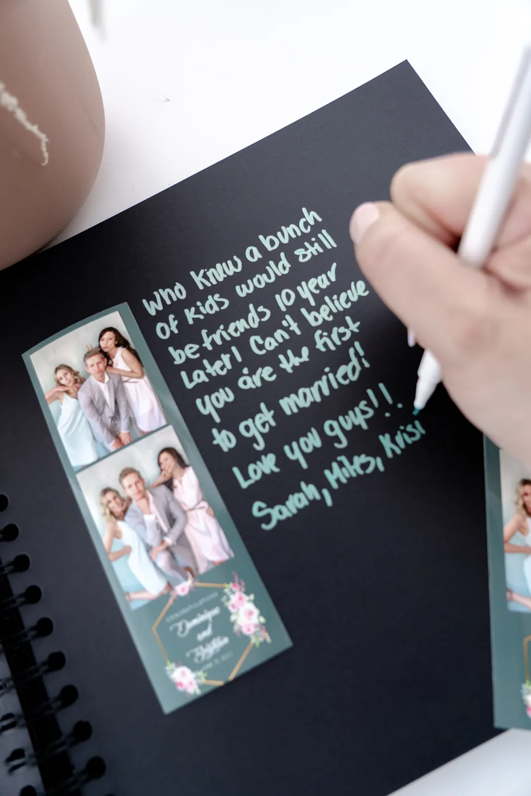 Guest writing a note next to a photo strip