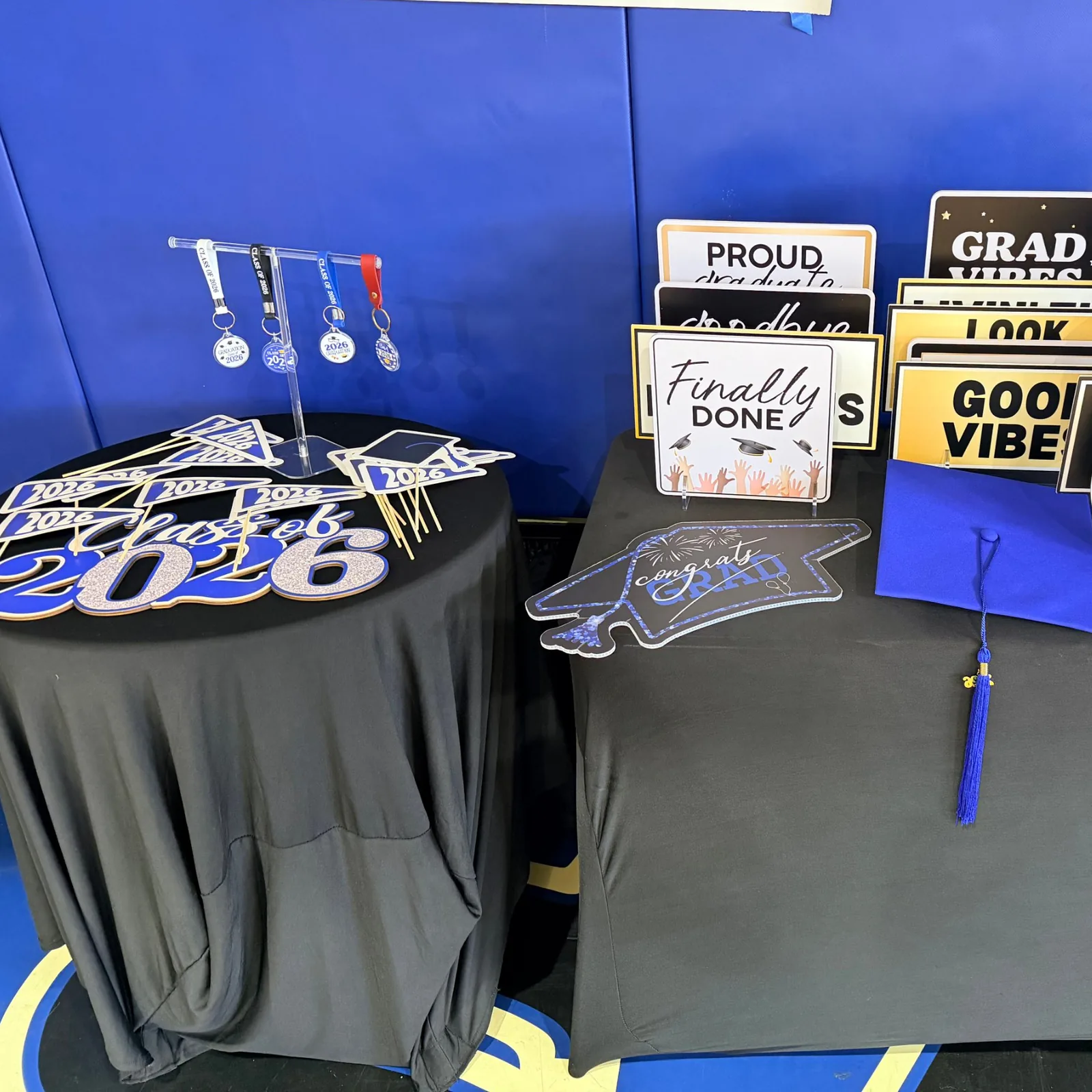 Graduation props table with signs, caps and keychains
