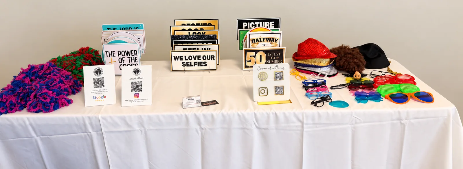 Props table with signs, hats, glasses and boas