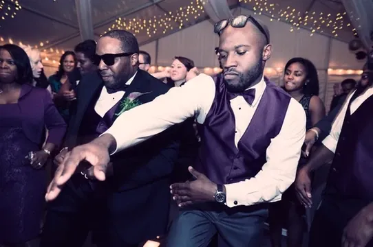 Groom dancing with guests